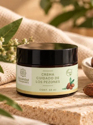 Crema Cuidado de los Pezones de Essential Therapeutics de 50 ml sobre piedra natural, acompañada de hojas verdes, flores pequeñas y textiles beige.